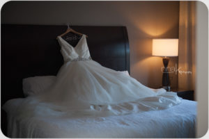 wedding gown on bed