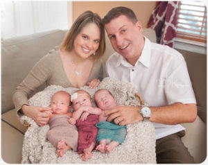 parents with newborn triplets