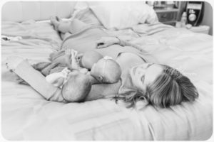 mom on bed with triplets