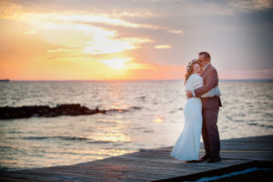 wedding couple on docks at sunset