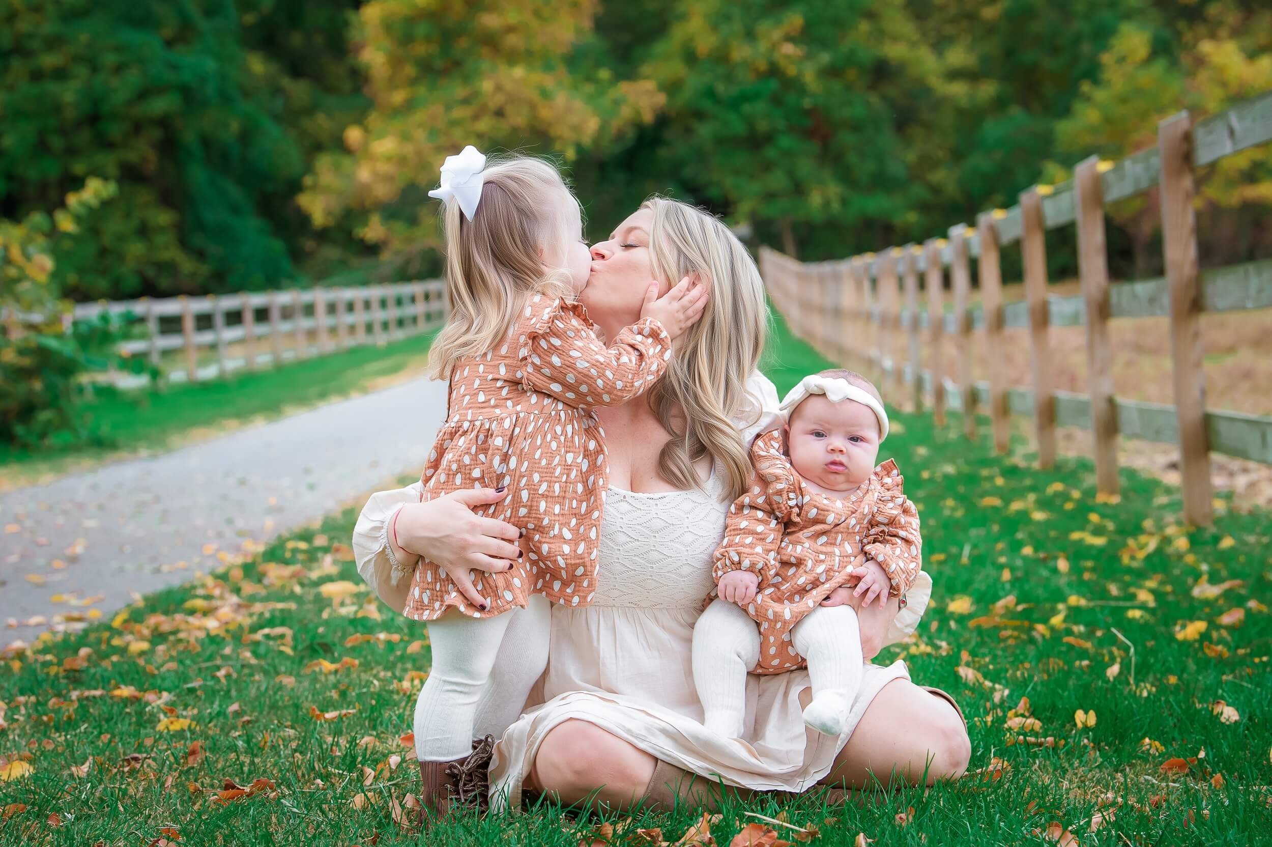 Family portrait photography by Maryland photographer Nina K, woman in cream dress with two young children, outdoor portraits