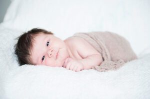 Newborn photography by Maryland photographer, Nina K, baby in tan blanket